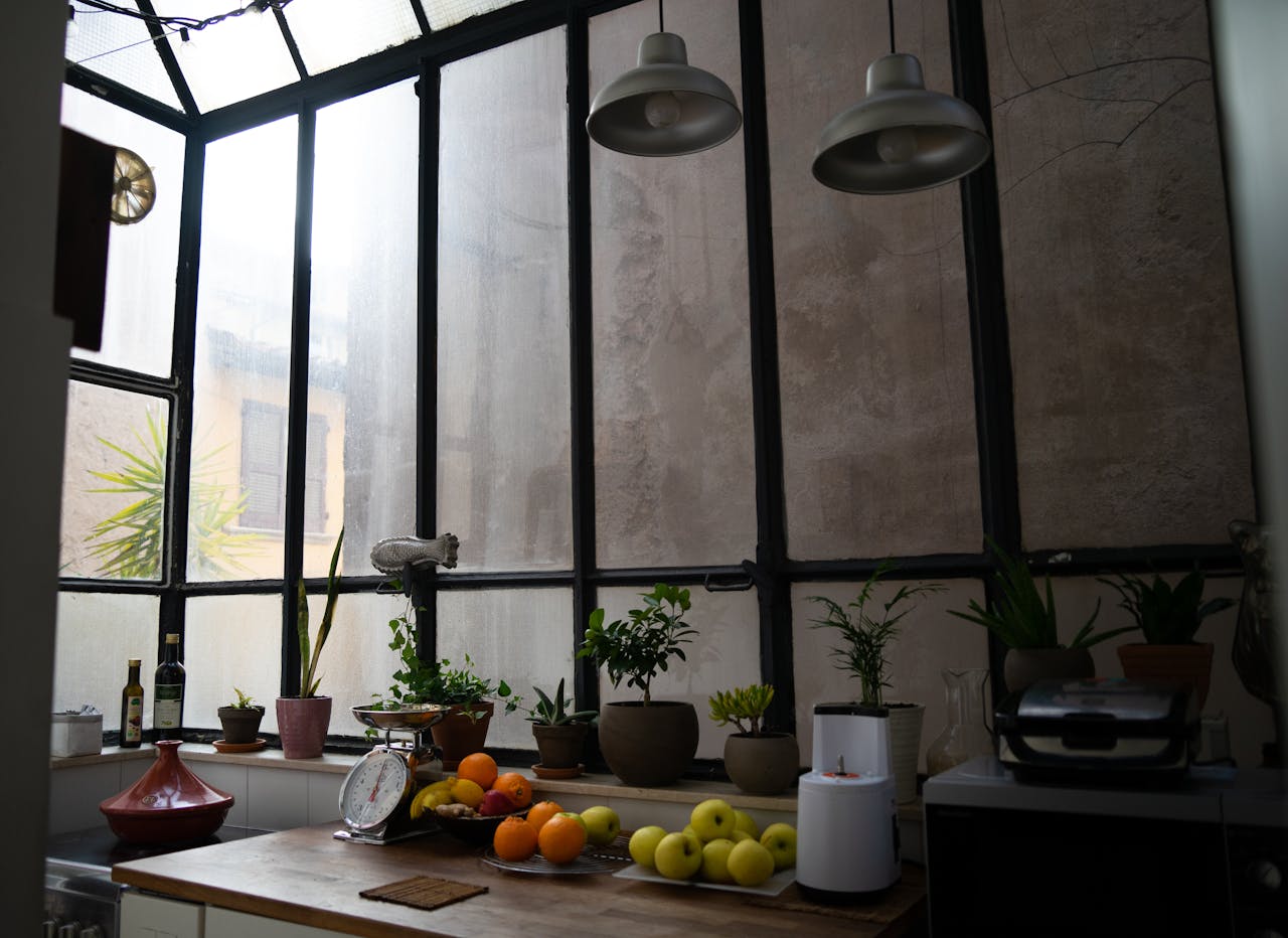 A kitchen with a window and a counter with fruit